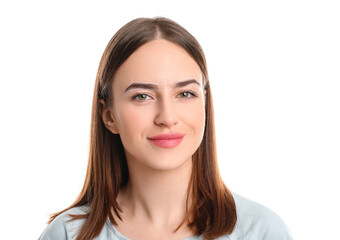 Fototapeta premium Young woman with marking for eyebrow correction against white background