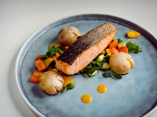 High resolution pink salmon steak with steamed veggies, a restaurant dish