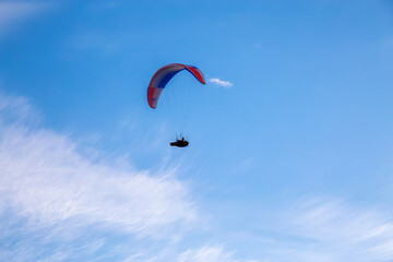 Paraglider flying Up High surrounded by Clouds in Canadian Nature. Taken in Tombstone Territorial Park, Yukon, Canada.