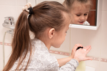 Hygiene. Hand cleaning. The child washes hands with soap