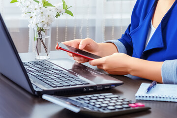 Remote work. Quarantine. Happy successful businessman working with phone and laptop at home