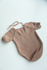 Various colors and types of cotton clothing, knitted newborn clothes and newborn hats on a white background.