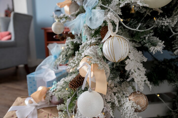 Pastel colored decoration for christmas.White and pink Christmas tree with toys: shiny balls, bows.Christmas tree with ornaments.winter holidays, new year celebration greeting card.modern design