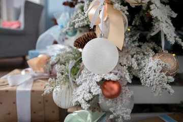 Pastel colored decoration for christmas.White and pink Christmas tree with toys: shiny balls, bows.Christmas tree with ornaments.winter holidays, new year celebration greeting card.modern design