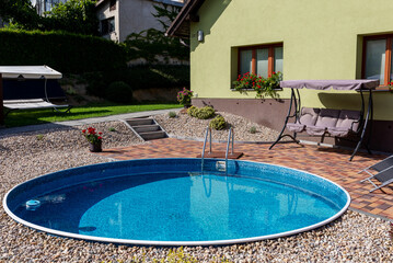 small home swimming pool with clear water in village house, Czech Republic