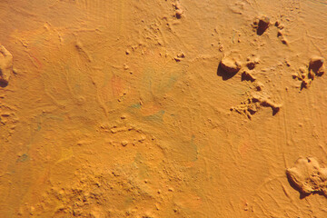 Stained painted wall surface in shades of sand and brown. rough plaster texture. sloppy bumpy staining, Grunge textured background with copy space