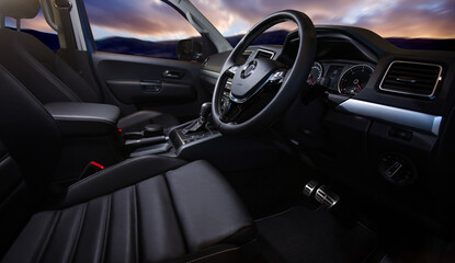 Fototapeta na wymiar Luxury car interior. Steering wheel, shift lever and dashboard.