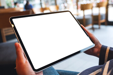 Mockup image of a woman holding digital tablet with blank white desktop screen