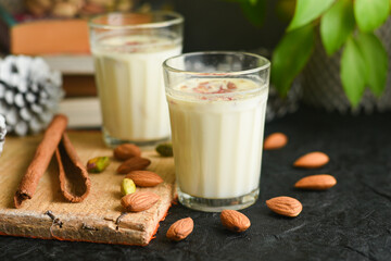 Kesar Badam milk shake or Almond Saffron milk prepared with almonds, spices and milk Kerala India. Kheer or North Indian traditional health drink Flavoured milk   badam lassi served with dry fruit