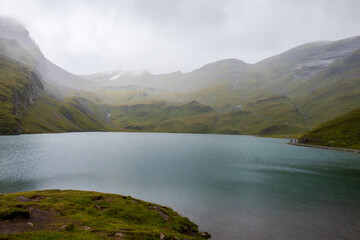 Bachalpsee on a cloudy, misty day near First, Switzerland in the Valais Alps. 