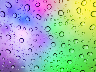 Image of water droplets on a multicolor surface during heavy rain.