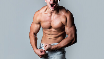 Muscular bodybuilder posing over white background. Muscular man screaming. Screaming man with well...
