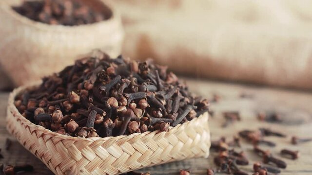 Dry clove on wooden background.