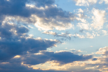cloudy sky in yellow light. natural background at sunrise. inspiring scene