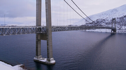 Side view of Kvalsund Bridge (Kvalsundbrua, length 741m) near Hammerfest, Norway, Scandinavia, a suspension bridge crossing Kvalsundet strait between mainland and Kvaløya island in winter time.
