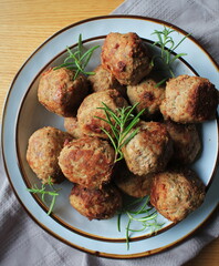 Roasted meatballs , delicious meat cutlets on wooden table . Top view .