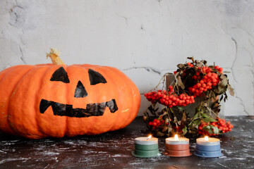 Big orange pumpkin for Halloween, burning candles