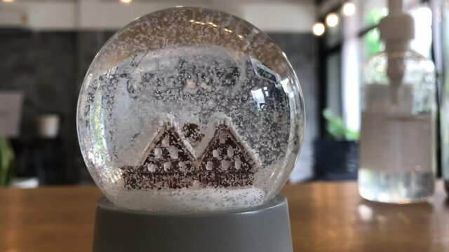 Christmas Snow globe Snowflake with Snowfall over little old houses