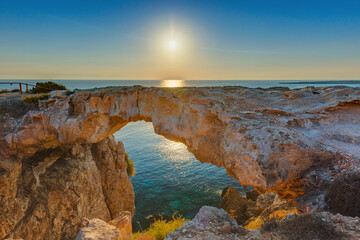 Fototapeta na wymiar Famous stone Sin Bridge at sunrise in Ayia Napa Cyprus