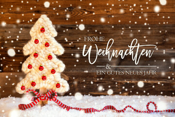 German Calligraphy Frohe Weihnachten Und Ein Gutes Neues Jahr Means Merry Christmas And A Happy New Year. White Fabric Christmas Tree With Red Ball Ornament. Wooden Background With Snow And Snowflakes