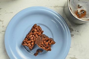 Chocolate bar on a plate with coffee