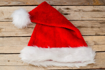 Obraz na płótnie Canvas Santa's little red riding hood on wooden background