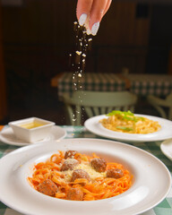 Healthy spaghetti dinner. Traditional Italian pasta with meatballs and cheese. Italian cuisine concept.