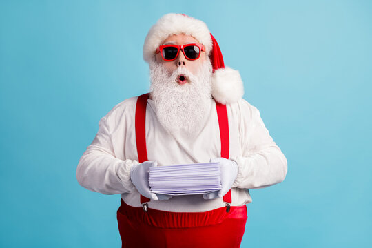 Portrait Of His He Nice Attractive Amazed Wondered Thick White-haired Santa Holding In Hand Pile Mail Letters Wish List December Tradition Isolated Bright Vivid Shine Vibrant Blue Color Background