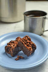 Chocolate bar on a plate with coffee