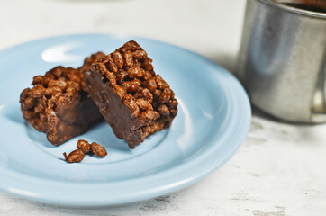 Chocolate bar on a plate with coffee