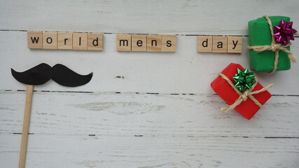 World men's day. lettering cleaning mask mustache gifts heart on a beautiful background