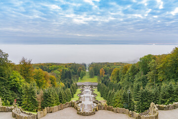 Fototapeta na wymiar The stairs with its water basins of the famous water features in the mountain park in Kassel, Germany, morning mist lies over the city