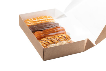 Set of five eclairs with various fillings in box isolate on white