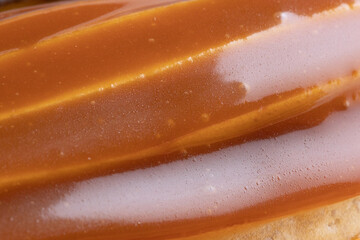 Eclair cake covered with salted caramel with caramel custard filling, close up