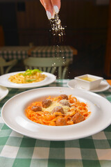 Healthy spaghetti dinner. Traditional Italian pasta with meatballs and cheese. Italian cuisine concept.