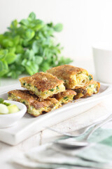 Martabak telur, Indonesian traditional savoury food made from egg, meat, and some spices. White plate and background.


