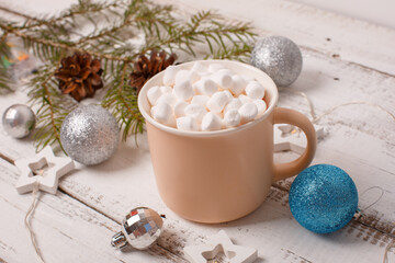 Obraz na płótnie Canvas Christmas background, coffee mug and marshmallow blue Christmas tree toys . Merry Christmas greeting card