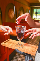 Many hands holding wine glass inside. Eating out in restaurant concept. Creative idea.