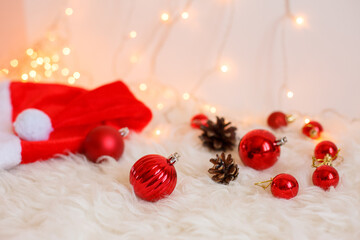 Christmas background, red Christmas tree toys, cones and glowing lights . Merry Christmas greeting card