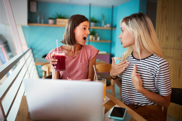 Friendship, happiness and people concept. Two smiling girls whispering gossip