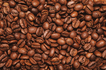 Top view of fresh roasted coffee beans background. Pile coffee texture beans