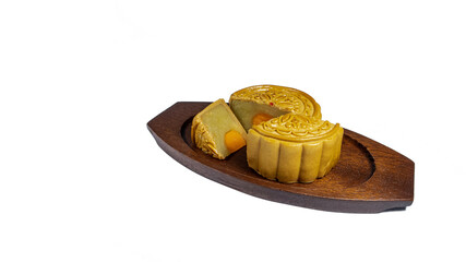 Mooncake, mid autumn festival cake on the wooden dish isolated on white background.