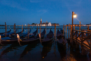 Gondolas in Venice night view from San Marco square in Italy.