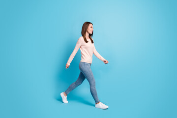 Fototapeta na wymiar Full length body size profile side view of her she nice attractive pretty thin cheerful brown-haired girl walking isolated over bright vivid shine vibrant blue color background