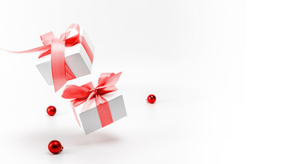 Christmas gift. White gift box with red ribbon, New Year balls in xmas composition on white...