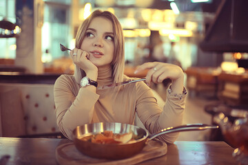 european restaurant lunch girl, beautiful table setting, young model posing while eating