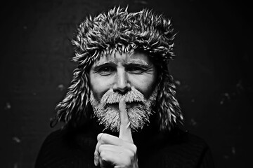 brutal man with a beard in winter clothes / portrait person with a gray beard, hipster warm clothes...