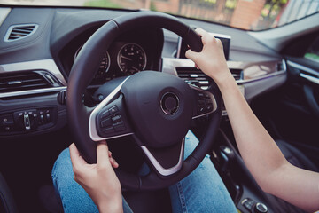 Cropped photo of cute pretty lady hands steering wheel road traveling ride highway turning beeping look speedometer use gps navigation professional driver skills wear white shirt indoors