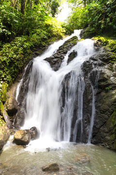 Rainforest waterfall long exposure image in lush tropical forest