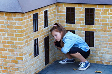 girl plays in a city Park with miniature houses